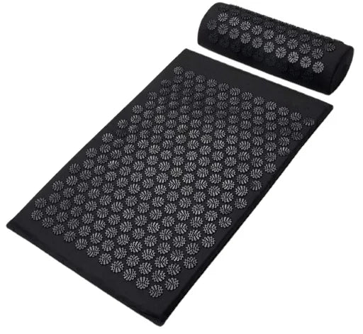 Acupressure yoga mat in black with a matching pillow, featuring scattered pressure points for relaxation and wellness.